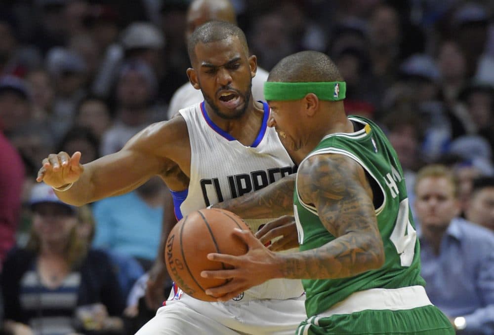 Boston Celtics guard Isaiah Thomas, right, drives against Los Angeles Clippers guard Chris Paul during yesterday's game in Los Angeles. The Clippers won 114-90. (Mark J. Terrill/AP)