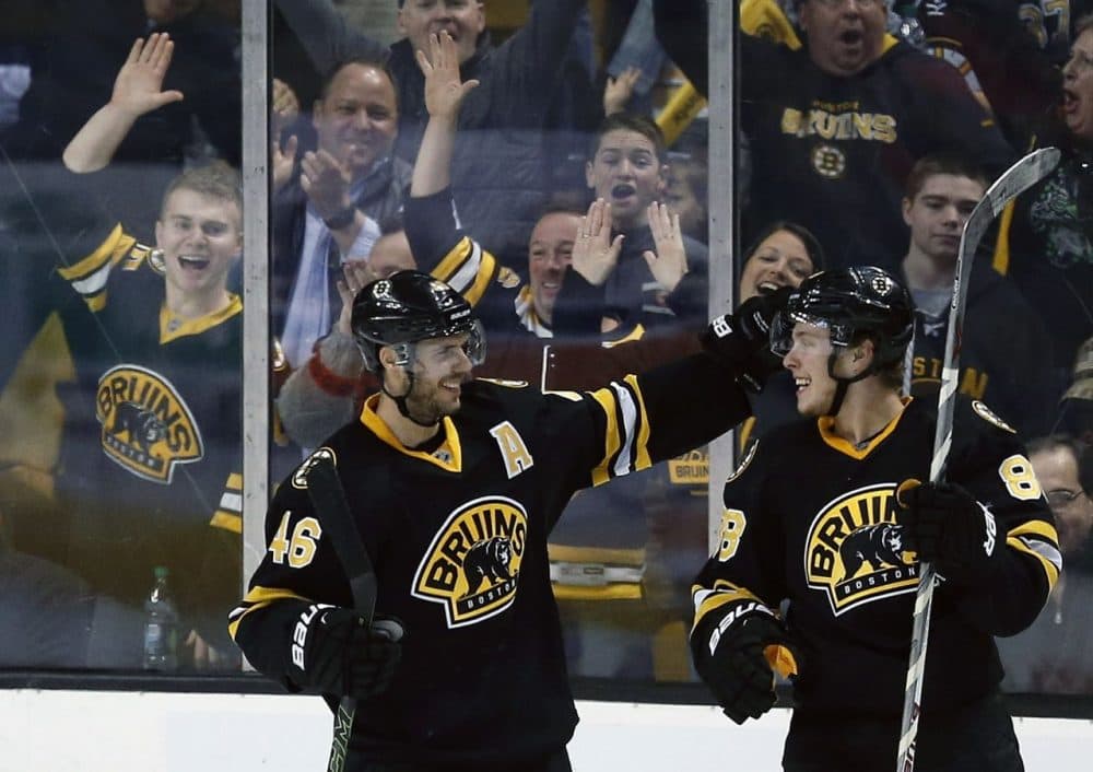 Bruins' David Pastrnak (88) celebrates his goal with David Krejci (46) during the third period a game against the New York Islanders in Boston on Saturday. (Michael Dwyer/AP)