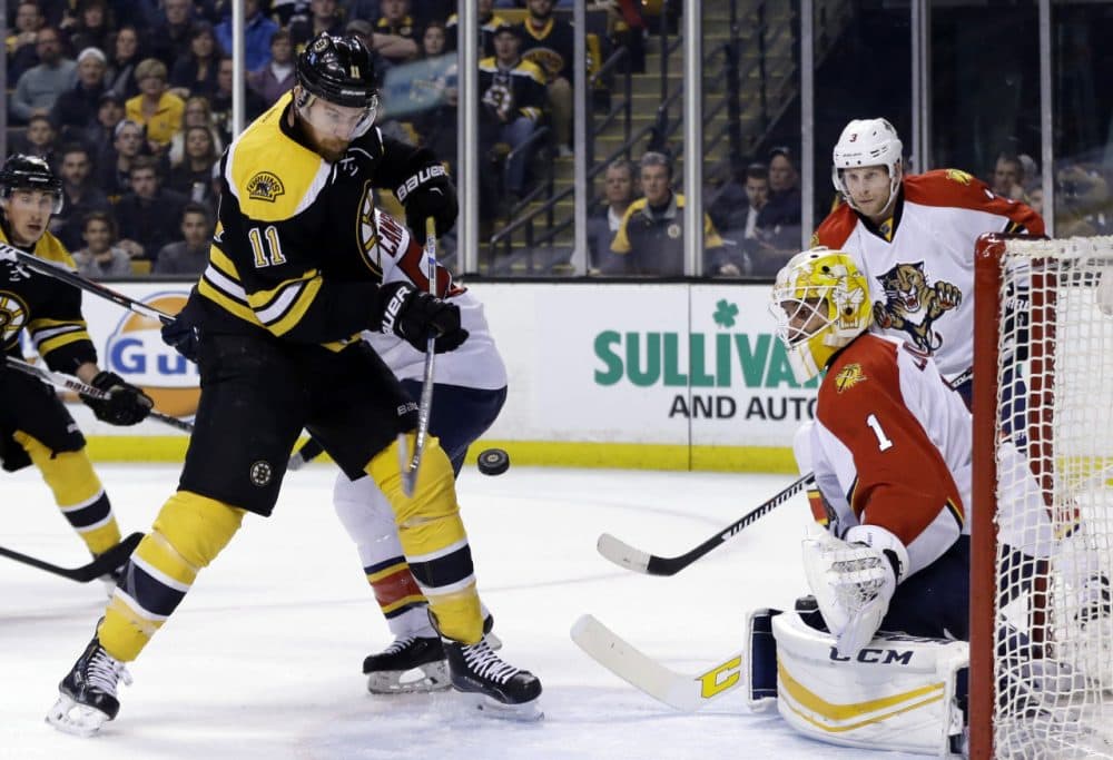 Bruins right wing Jimmy Hayes (11) tries to bat the puck in, but doesn't score against Florida Panthers goalie Roberto Luongo (1) in Thursday night's game in Boston. (Elise Amendola/AP)