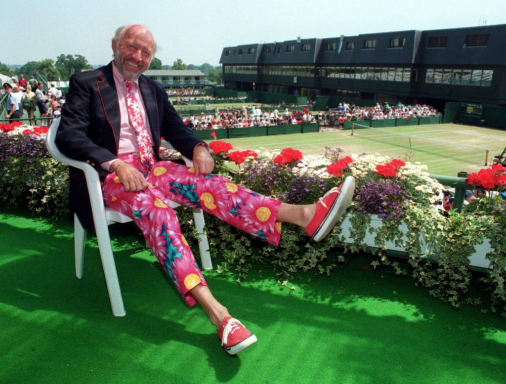Sports journalist Bud Collins displays a pair of brightly-colored trousers as he sits overlooking the outside courts at Wimbledon in 1993. One of the country’s foremost authorities on professional tennis, Collins died Friday at his home in Brookline. He was 86. (Gill Allen/AP)