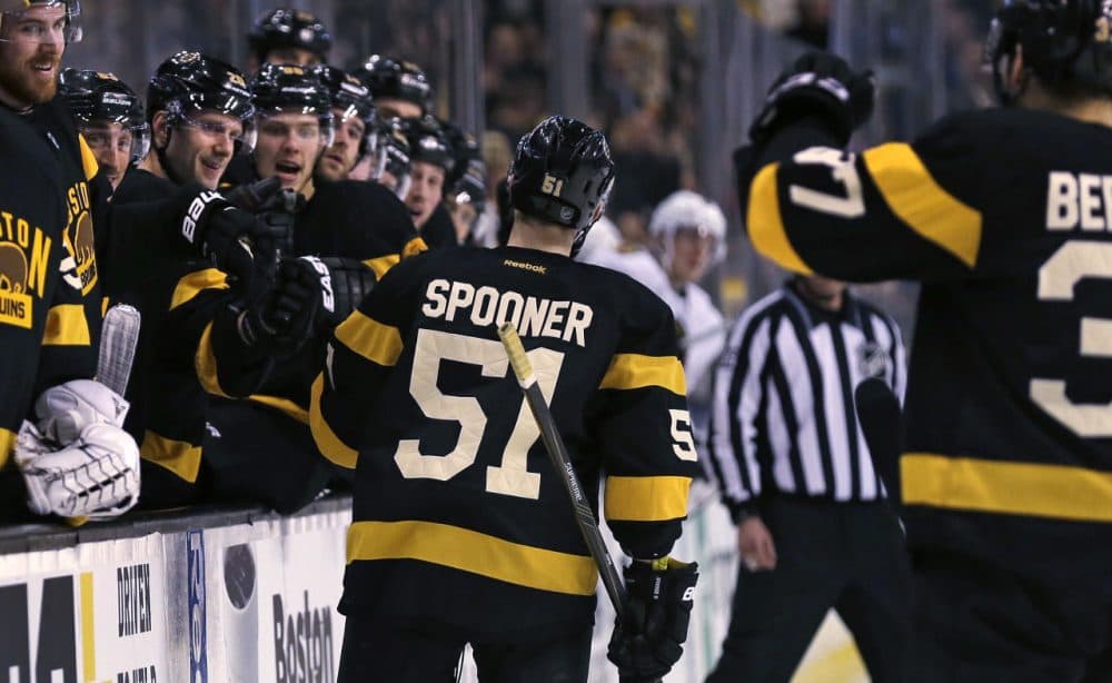 Bruins center Ryan Spooner is congratulated by teammates after his goal against the Blackhawks in the second period Thursday in Boston. (Charles Krupa/AP)