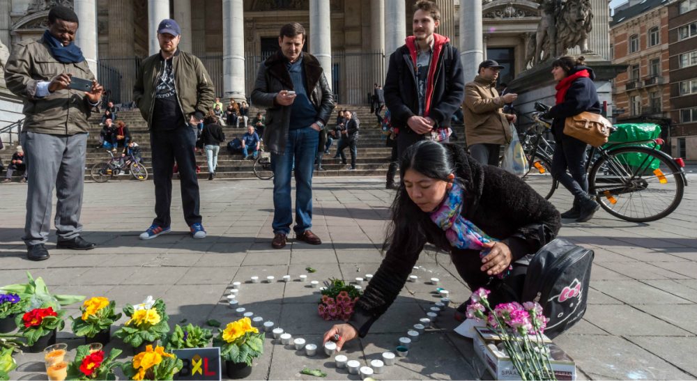 Mark Edington: &quot;The coincidence of our week of remembrance and Resurrection with the horrors of bombs and blood confronts us with a perplexing sorrow.&quot;  Pictured: A woman places candles in the shape of a heart outside the stock exchange in Brussels on Tuesday, March 22, 2016. (Geert Vanden Wijngaert/AP)