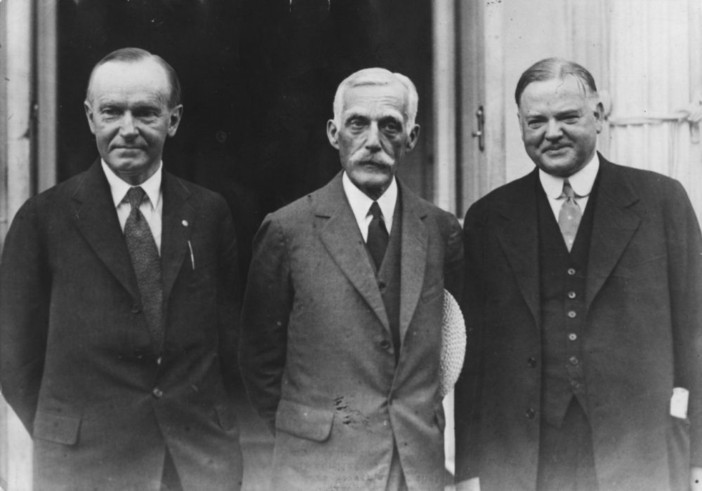 American President Calvin Coolidge (1872 - 1933) with Secretary of the Treasury Andrew Mellon (1855 - 1937) and future President Herbert Hoover (1874 - 1964) outside the White House after discussions.  Original Publication: People Disc - HC0289   (Photo by Keystone/Getty Images)