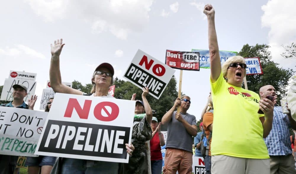 Opponents of Kinder Morgan's proposed natural gas pipeline protest on Boston Common on July 30, 2014. (Charles Krupa/AP)