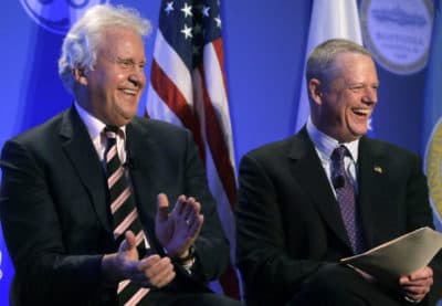 General Electric CEO Jeff Immelt, left, and Gov. Charlie Baker smile during a news conference in Boston on Monday. (Steven Senne/AP)