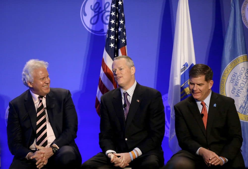 Massachusetts Gov. Charlie Baker, center, takes a question from a reporter as General Electric CEO Jeff Immelt, left, and Boston Mayor Marty Walsh, right, look on during a news conference in Boston, Monday, April 4, 2016. The conference was held to unveil more details about GE's move to the city. (Steven Senne/AP)