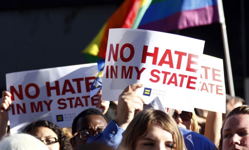Protesters call for Mississippi Gov. Phil Bryant to veto House Bill 1523, which they says will allow discrimination against LGBT people, during a rally outside the Governor's Mansion in Jackson, Miss., on Monday. The governor signed the bill into law yesterday. (Rogelio V. Solis/AP)