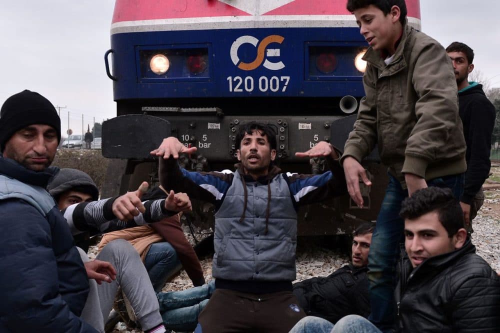 Syrian and Iraqi refugees trapped at the Greek-Macedonian borders stop an arriving train during their protest demanding the opening of the borders on February 28 , 2016. 
A number of Balkan countries have closed their borders to migrants. (Louisa Gouliamaki/AFP/Getty Images)