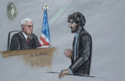 In this courtroom sketch, Boston Marathon bomber Dzhokhar Tsarnaev stands before U.S. District Judge George O'Toole Jr. as he addresses the court during his sentencing to apologize, just before the judge formally sentenced him to death. (Jane Flavell Collins/AP)
