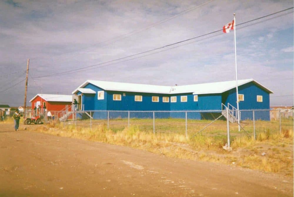 Office of the Attawapiskat First Nation in Attawapiskat, Ontario. The red building at left is post office. This photograph was taken in the early 1990s. (Paul Lantz/Wikimedia Commons)