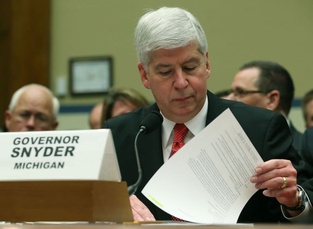 Gov. Rick Snyder, (R-MI), looks at papers during a House Oversight and Government Reform Committee hearing, about the Flint, Michigan water crisis, on Capitol Hill March 17, 2016 in Washington, DC. The committee is examining how lead ended up in the public drinking water in Flint, Michigan. (Mark Wilson/Getty Images)