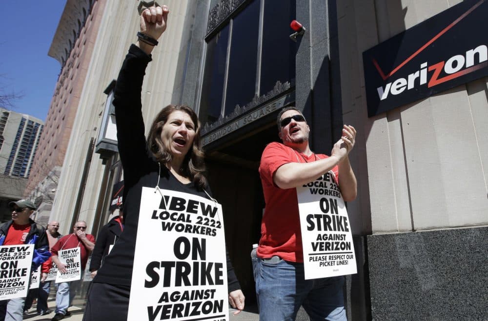 Verizon workers picket outside one of the company's facilities Wednesday in Boston. Members of the Communications Workers of America and the International Brotherhood of Electrical Workers went on strike Wednesday morning on the East Coast. (Steven Senne/AP)