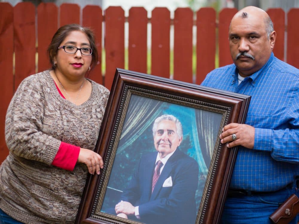 Patty Rodriguez and her brother, Alex, hold a photo of their late father Demetrio Rodriguez on Sunday, March 1, 2015 in San Antonio. (Bahram Mark Sobhani)