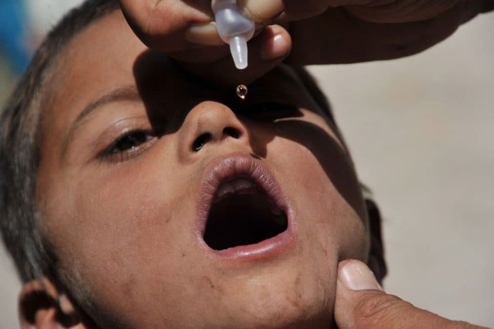 An Afghan health worker administers the polio vaccine to a child during a vaccination campaign on the outskirts of Jalalabad in Nangarhar province on June 24, 2014. A new three-day nationwide immunisation campaign against polio supported by Afghanistan's Ministry of Public Health had begun, officials said.  (Noorullah Shirzada/AFP/Getty Images)