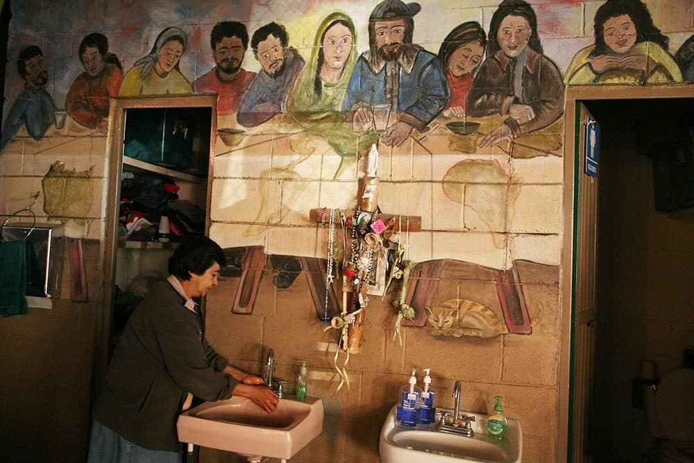 Churches are helping migrants across the world – at the United States-Mexico border, as well as in Europe. Above, a nun washes her hands at El Comedor, a free dining hall in the Mexican border town of Nogales. (Stina Sieg/KJZZ)
