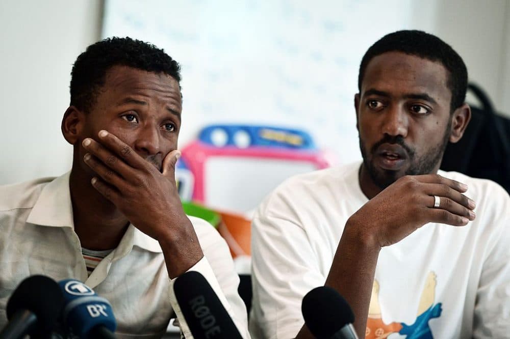 Survivors of a deadly shipwreck, Ismam Mowlid of Somalia (L) and Mahmud Muaz of Ethiopia react during a press conference in Athens on April 21, 2016.
The UN refugee agency fears around 500 migrants from Africa had drowned in the Mediterranean, in what could be one of the worst tragedies since the start of the migrant crisis in Europe. The 41 survivors (37 men, three women and a three-year-old child) were rescued by a merchant ship and taken to Kalamata, in the Peloponnese peninsula of Greece on April 16. Those rescued include 23 Somalis, 11 Ethiopians, 6 Egyptians and a Sudanese. (LOUISA GOULIAMAKI/AFP/Getty Images)