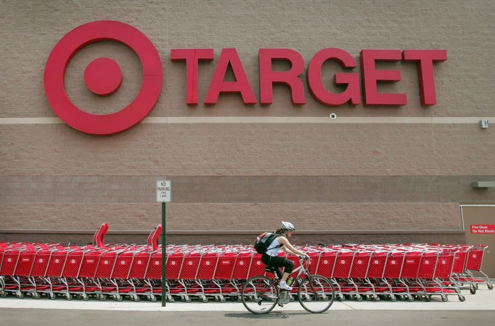 A bicyclist rides past a row of shopping carts outside a Target store on May 23, 2007 in Chicago, Illinois. (Photo by Scott Olson/Getty Images)