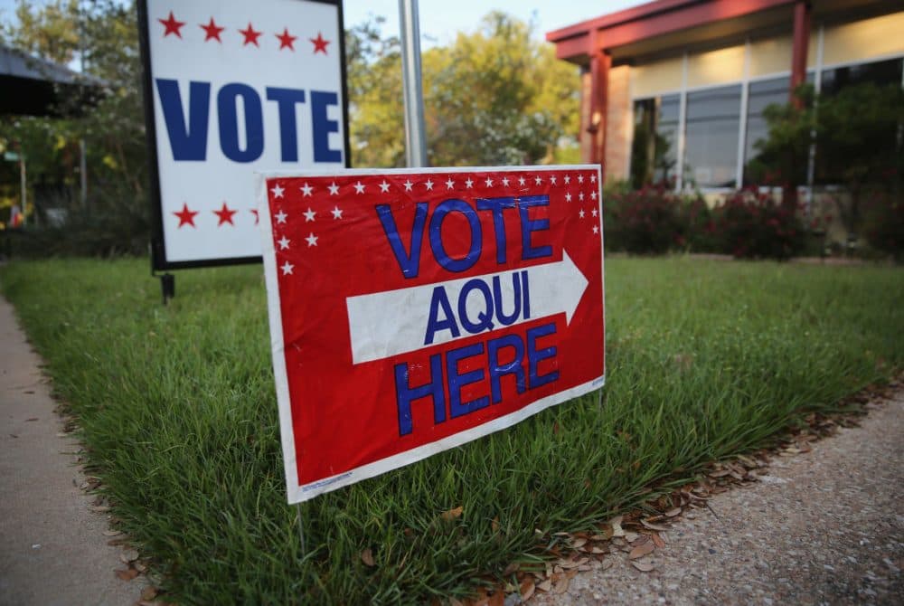 A bilingual sign stands outside a polling center at public library ahead of local elections on April 28, 2013 in Austin, Texas. Early voting was due to begin Monday ahead of May 11 statewide county elections.  (John Moore/Getty Images)