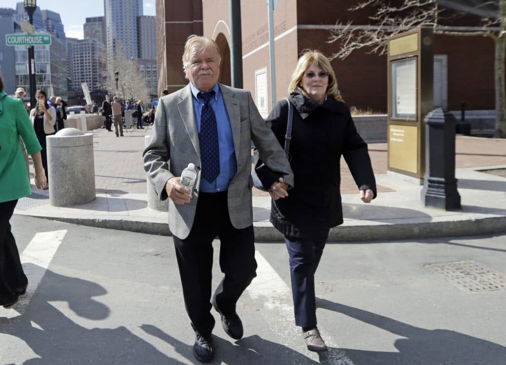 Robert Fitzpatrick walks from federal court in Boston in April 2015, accompanied by his wife, Jane. (Elise Amendola/AP)