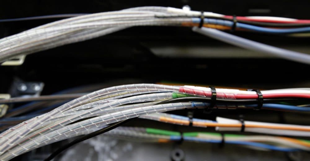Verizon is now bringing the high speed Internet and cable television competition it already offers in other parts of Massachusetts to Boston. Pictured: Glass fibers, housed inside narrow cables, are seen as they're being connected to the Verizon Fios fiber network in Rockville, Maryland. (Alex Brandon/AP)
