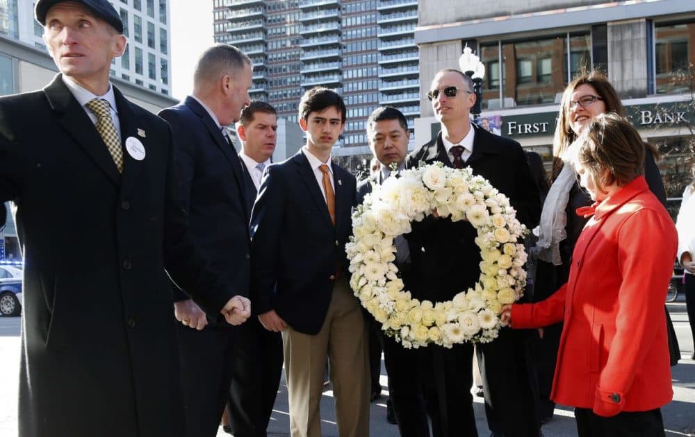 Members of the Richards family, along with the father of victim Lingzi Lu, Jun Lu, fourth from right, Boston Police Commissioner William Evans, left, and Mayor Marty Walsh prepare to place a wreath on the third anniversary of the bombings on Friday in Boston. (Michael Dwyer/AP)