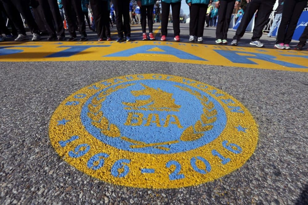 The 2016 start line for the Boston Marathon features a seal honoring 50 years of women running (Michael Dwyer/AP)