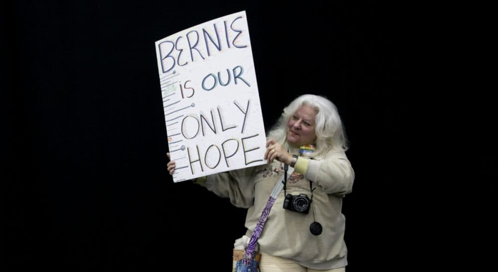 An exhortation, in verse, to Bernie-or-Bust supporters in New York and beyond to embrace pragmatism -- and Hillary Clinton -- come November. Pictured: Patrice Fowler, right, of Edinboro, Pa., holds a sign while waiting for Democratic presidential candidate, Sen. Bernie Sanders, I-Vt., to arrive during a campaign rally in Erie, Pa., Tuesday, April 19, 2016. (Mary Altaffer/AP)