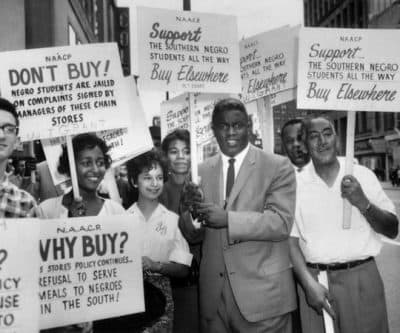 Former baseball star Jackie Robinson grabbed a sign and joined a picket line in Cleveland, Ohio, to protest discrimination against blacks at southern lunch counters, 1960. The picketing was organized by the NAACP. (AP)