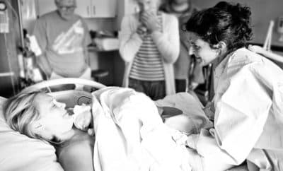 August 8, 2013: Sarah Jaggar and midwife Stephanie Avila share a moment of gratitude just seconds after the safe arrival of a healthy baby girl. (Photo: Orchard Cove Photography)