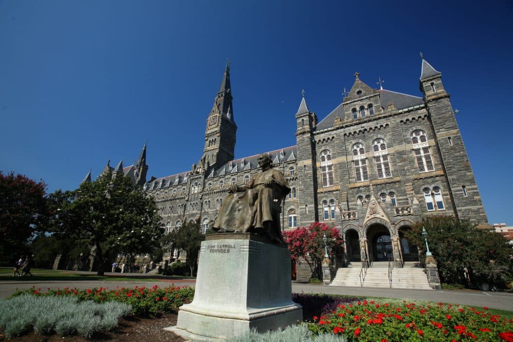 Healy Hall at Georgetown University in Washington, D.C., and a statue of Georgetown's founder, John Carroll. (ehpien/Flickr)