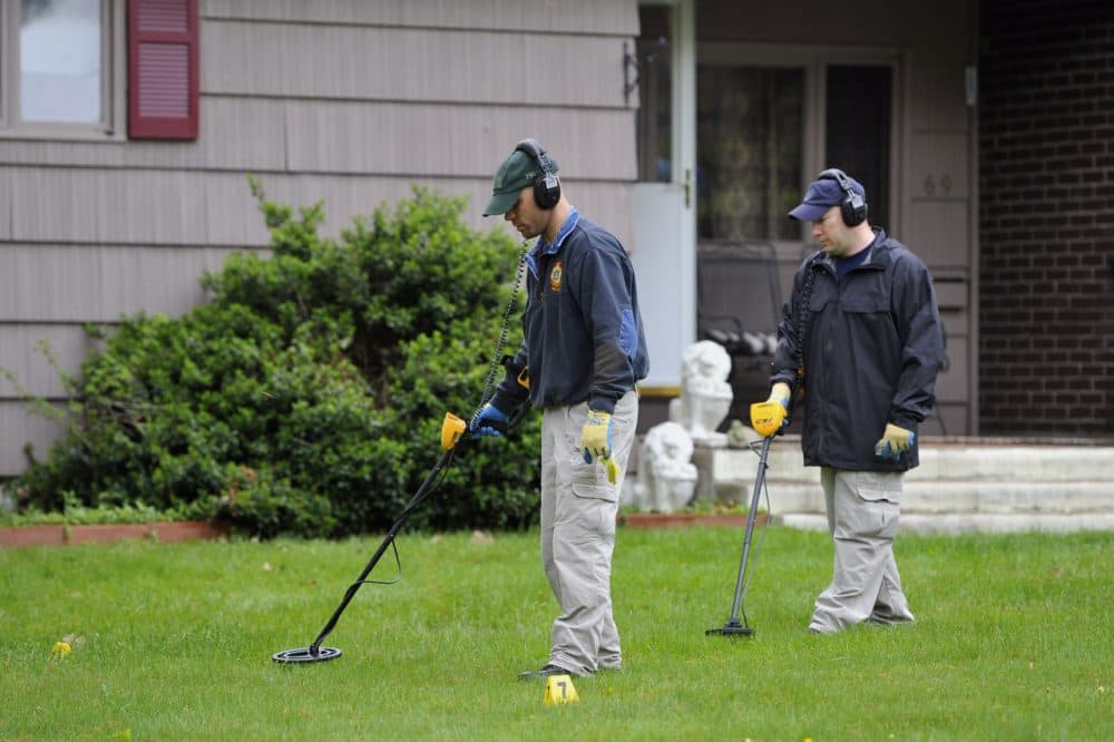 Law enforcement agents search the yard at Robert Gentile's Manchester, Conn. home in 2012. (Jessica Hill/AP)