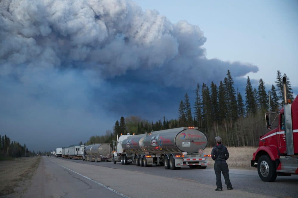 Drivers wait for clearance to take firefighting supplies into town on May 05, 2016 outside of Fort McMurray, Alberta. Wildfires, which are still burning out of control, have forced the evacuation of more than 80,000 residents from the town.   (Scott Olson/Getty Images)