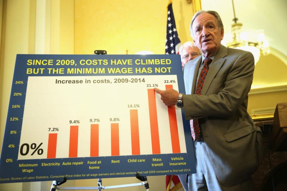 U.S. Sen. Tom Harkin (D-IA) (R) points to a chart as Rep. George Miller (D-CA) (L) looks on during a news conference July 24, 2014 on Capitol Hill in Washington, DC. The news conference was to call on Congress to raise the national minimum wage.  (Alex Wong/Getty Images)