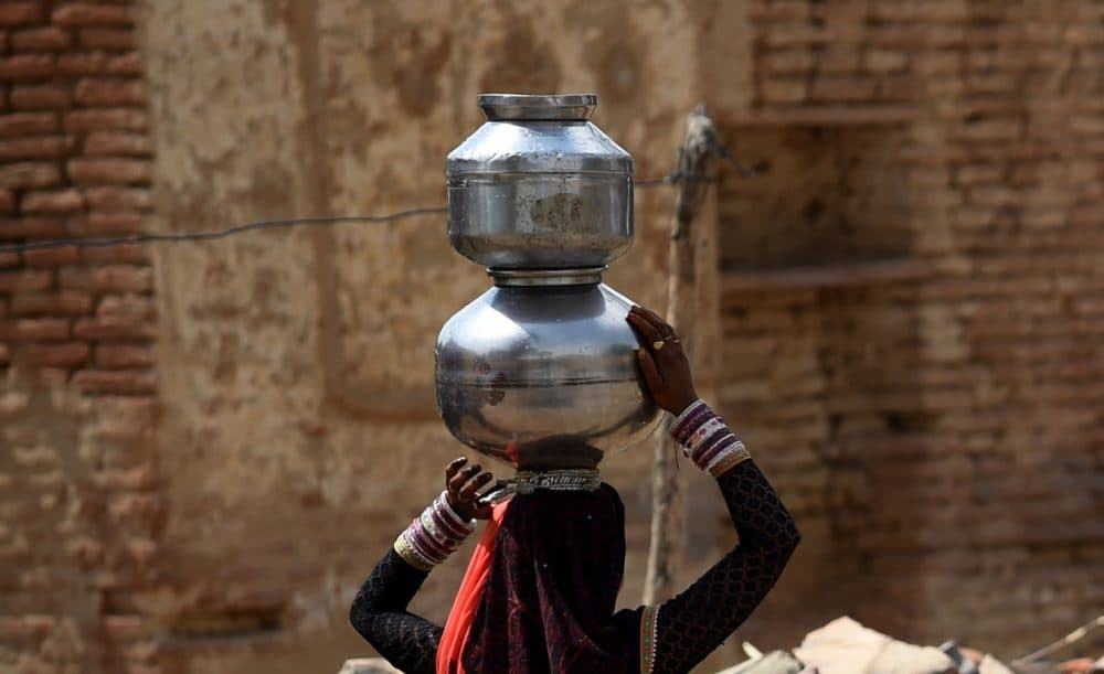 In this photograph taken on April 27, 2016, an Indian villager carries pots of water after filling them from from a well in the village of Dargai Khurd in Mohanganj area on the outskirts of Tikamgarh district in the central Indian state of Madhya Pradesh.
Tikamgarh is part of central India's parched Bundelkhand region -- consisting of 13 districts, half of which lie in neighbouring Uttar Pradesh state- which is reeling from years of below-par monsoon rains. (Money/Sharma/AFP/Getty Images)