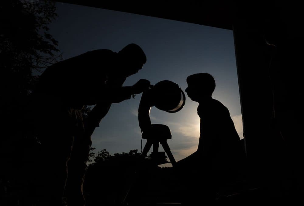 An Indian instructor helps an enthusiast to watch images of Mercury's transit through a reflection from a telescope at The Birla Planetarium in Chennai on May 9, 2016
Astronomers are preparing for one of the highlights of the skywatchers' year, when the Sun, Mercury and Earth all line up -- a phenomenon that happens just a dozen or so times per century.  (ARUN SANKAR/AFP/Getty Images)