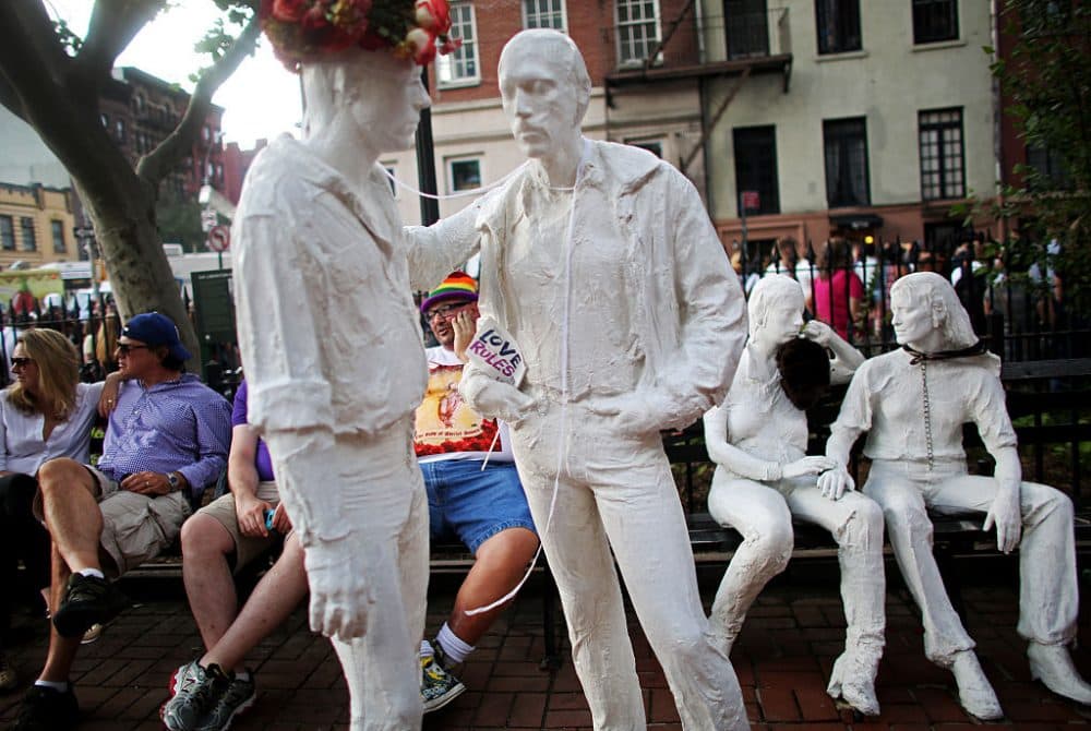Statues decorated with signs in favor of gay rights mix with a crowd in front of the Stonewall Inn during a rally in support of the Supreme Court's landmark decision guaranteeing nationwide gay marriage rights on June 26, 2015 in New York City. Today the high court ruled 5-4 that the Constitution guarantees a right to same-sex marriage in all 50 states. (Yana Paskova/Getty Images)