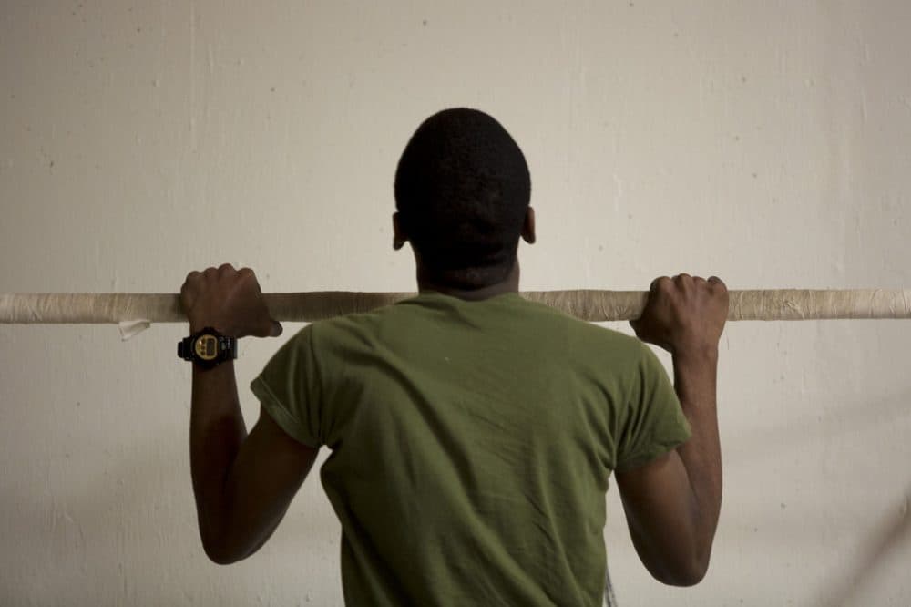 Madison Park Technical Vocational High School student Kavelle Toppin, a member of the Marine Corps Junior ROTC program, does pull-ups. (Jesse Costa/WBUR)