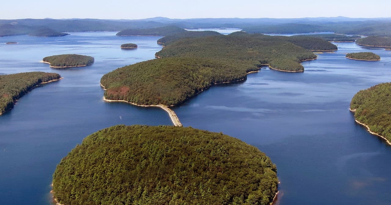 In this September 2013 handout photo, a dirt road leads to Mount Zion Island, at rear, at the Quabbin Reservoir in Petersham. State officials have a plan to start a colony of venomous timber rattlesnakes on the off-limits island. (Clif Read/Mass. Dept. of Conservation and Recreation via AP)