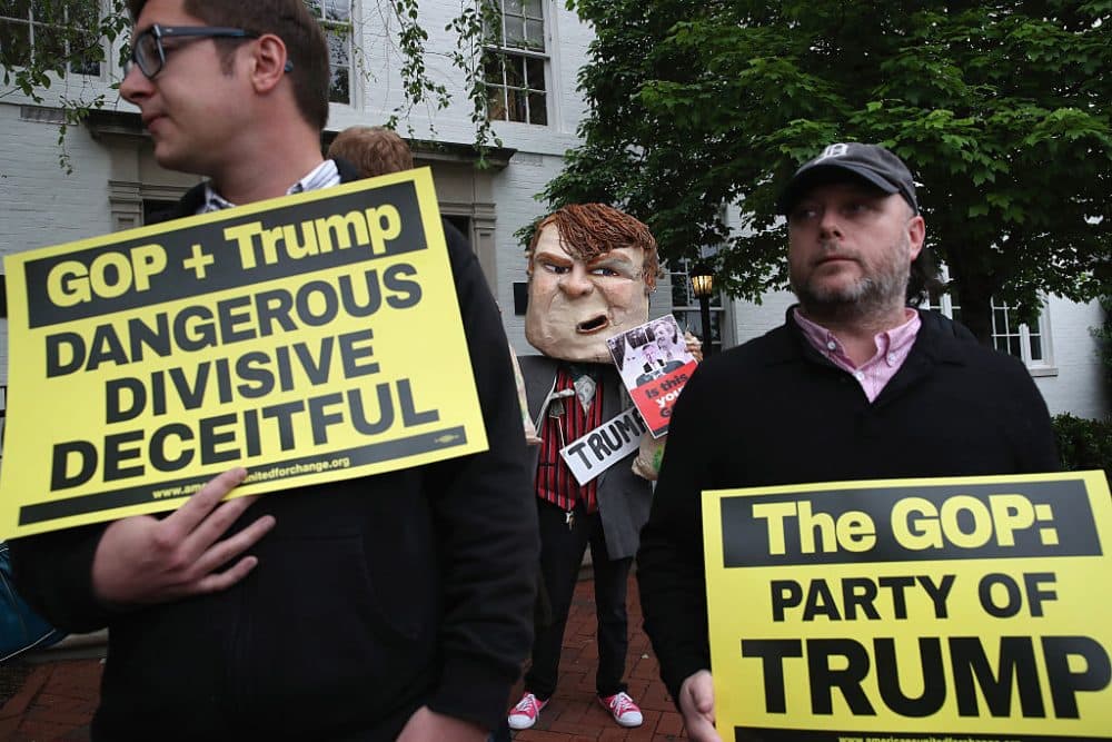 Protesters gather outside of the RNC headquarters where Republican presidential candidate Donald Trump is meeting with House Speaker Paul Ryan (R-WI), May 12, 2016 in Washington, DC. Ryan hopes the meeting to focus on substantive efforts at finding common ground to bridge the Republican party. (Photo by Mark Wilson/Getty Images)
