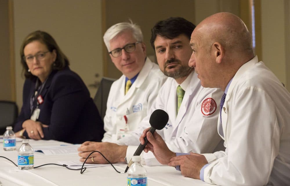Dr. Joshua Safer speaks at a press briefing at Boston Medical Center as Kate Walsh, president and CEO of BMC, Dr. Gerard Doherty, chief of surgery,  and Dr. Jaromir Slama, chief of plastic surgery look on. (Jesse Costa/WBUR)