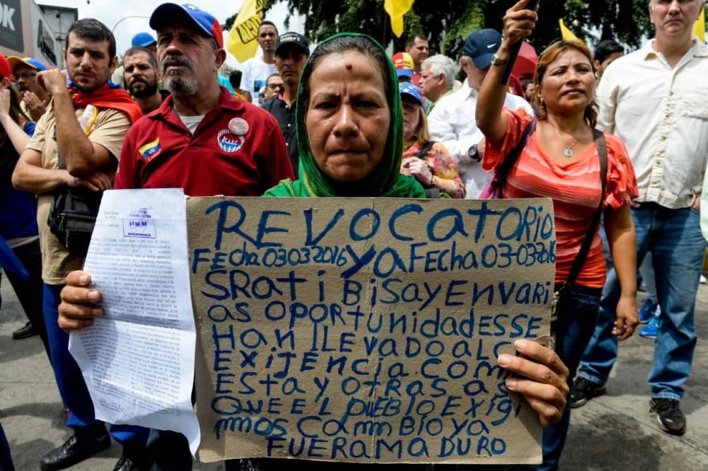 Opponents of the government of Venezuelan President Nicolas Maduro take part in a demonstration in Caracas on May 14, 2016. Venezuela braced for protests Saturday after Maduro declared a state of emergency to combat the &quot;foreign aggression&quot; he blamed for an economic crisis that has pushed the country to the brink of collapse. (Federico Parra/AFP/Getty Images)