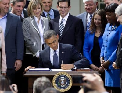 President Barack Obama signs the Jumpstart our Business Startups (JOBS) Act in 2012. (Carolyn Kaster/AP)