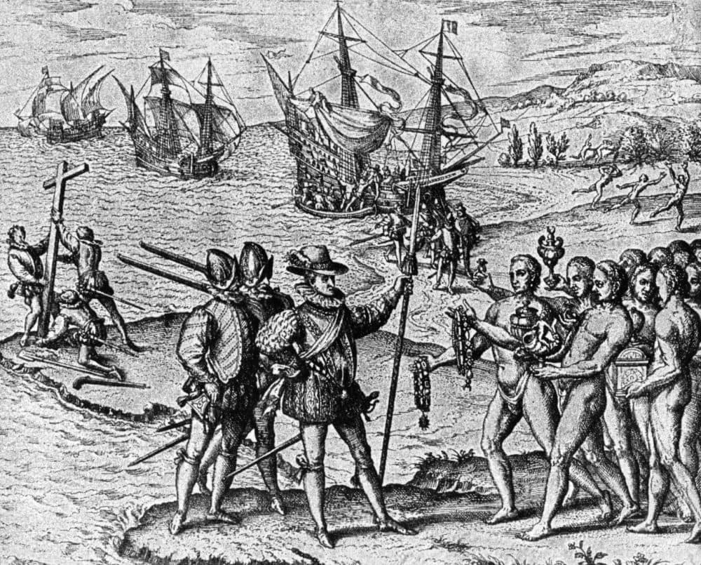 1492, Christopher Columbus (1446 - 1506) lands on Watling Island and meets the natives, while three of his shipmates erect a cross. (Photo by Hulton Archive/Getty Images)