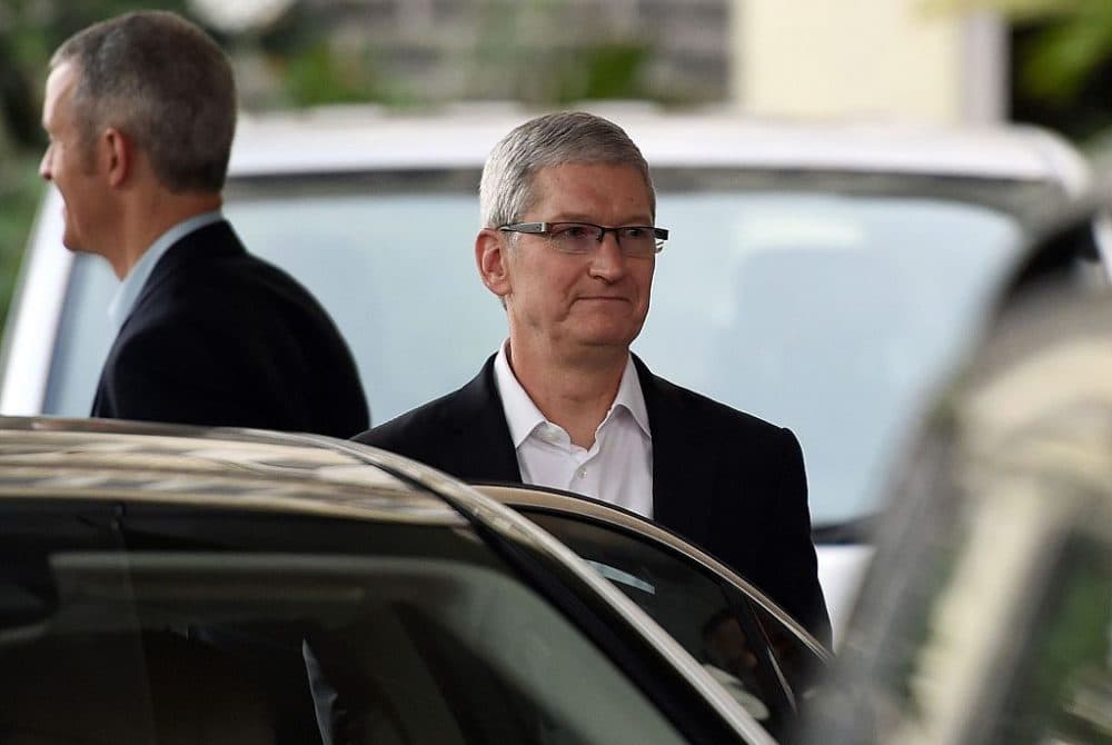 Apple chief executive Tim Cook (C) leaves the Taj Mahal Palace hotel in Mumbai on May 18, 2016.
Apple chief executive Tim Cook announced May 18 a new app design centre in India as he kicked off his first visit to the Asian giant seeking to tap into its roll-out of 4G networks. Cook landed in the Indian financial capital Mumbai shortly before midnight on May 17 by private jet from China, where he made a $1 billion announcement.
(PUNIT PARANJPE/AFP/Getty Images)