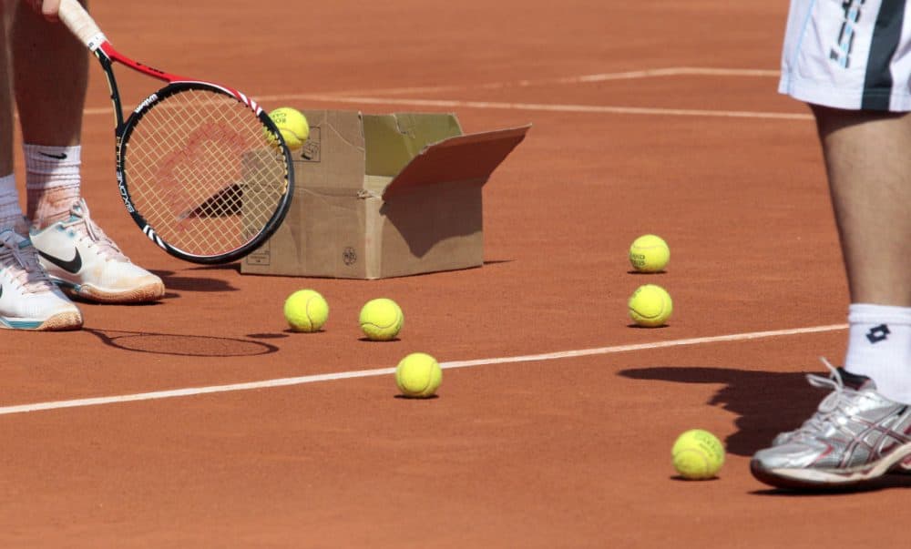 Players open a box of tennis balls during a training at Roland-Garros tennis stadium in Paris, on May 20, 2010, three days ahead of the French Open, the second Grand Slam tournament of the season.        AFP PHOTO JACQUES DEMARTHON        (Photo credit should read JACQUES DEMARTHON/AFP/Getty Images)