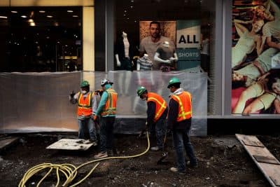 Workers dig to clear cement and soil to rebuild a footpath at the Times Square in New York on May 5, 2016. An increase in layoffs pushed US claims for unemployment insurance higher last week but the jobs market remains tight, Labor Department data showed. (Jewel Samad/AFP/Getty Images)