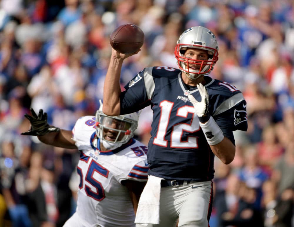 New England Patriots quarterback Tom Brady (12) throws under pressure by Buffalo Bills defensive end Jerry Hughes (55) during the second half of an NFL football game on Sunday. (Gary Wiepert/AP)