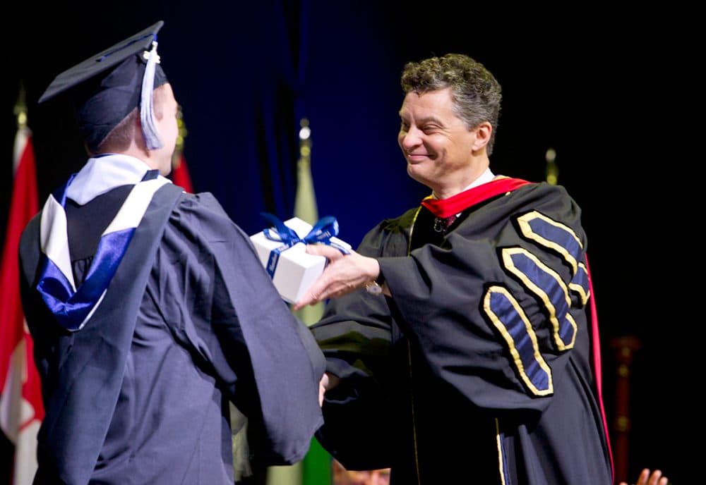 Dean of Students Patrick Reynolds hand out an award to a student doing the 2016 Commencement Ceremony at Hamilton College on Sunday, May 22, 2016 in Clinton, NY. (NANCY L. FORD)