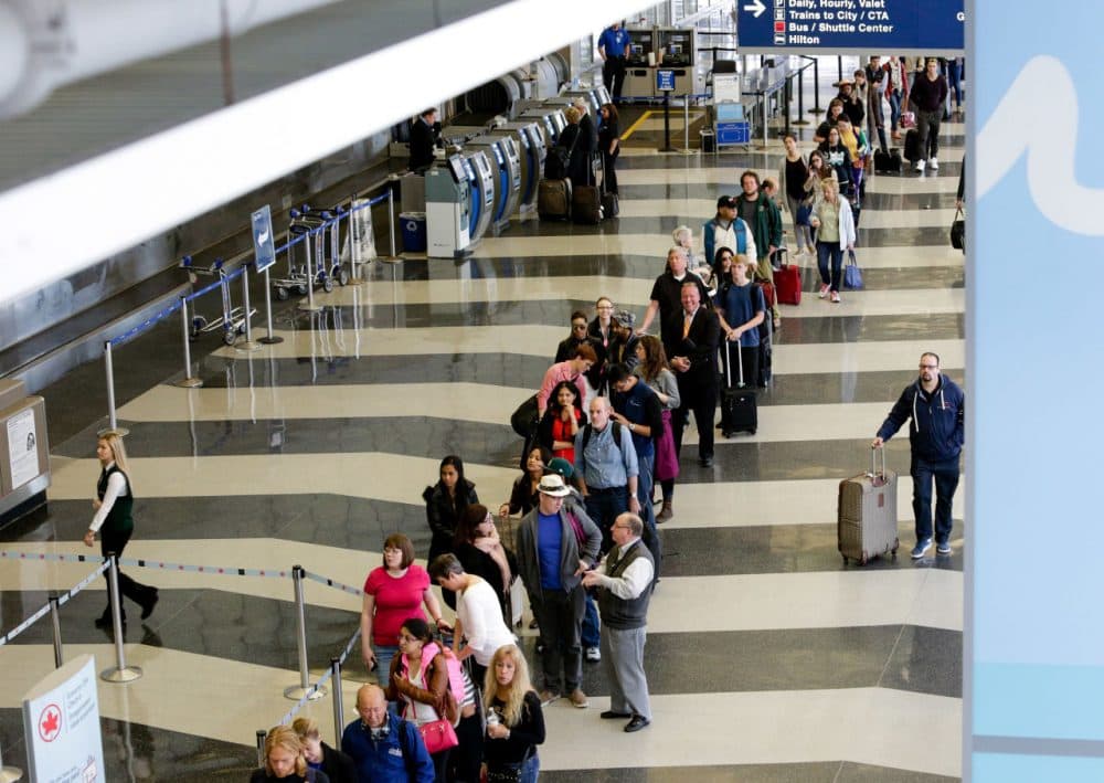A long line of travelers wait for the TSA security check point at O'Hare International airport, in Chicago on May 16, 2016.  As airport security lines get longer, the finger-pointing over blame is growing too. (Teresa Crawford/AP)