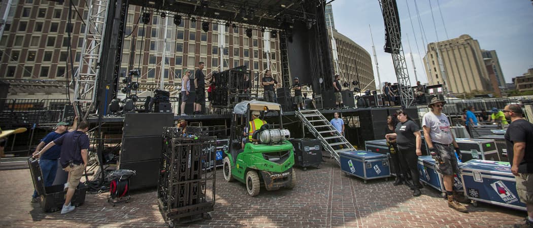 Workers begin to transform the brick City Hall Plaza Thursday for the three-day music fest over the weekend. (Jesse Costa/WBUR)